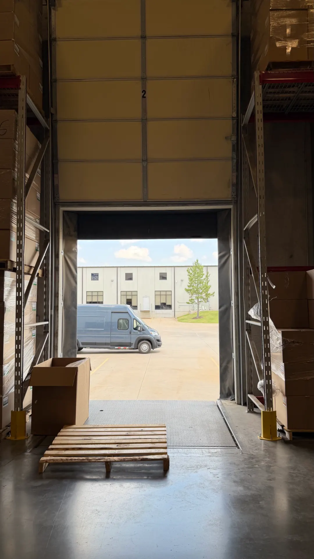 Open dock door number 2 with a delivery van parked outside